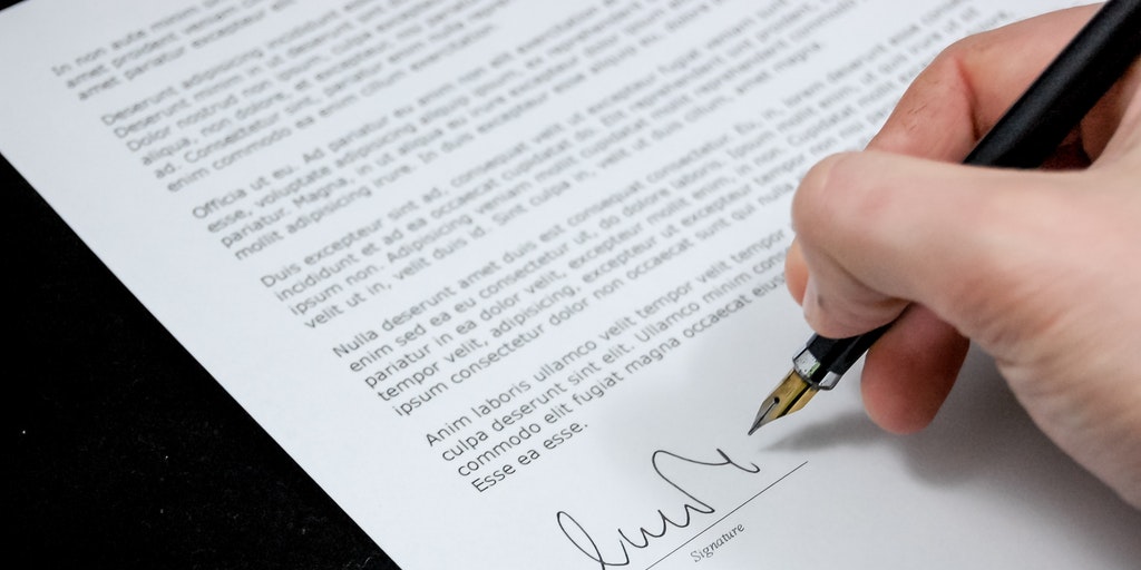 A letter being signed