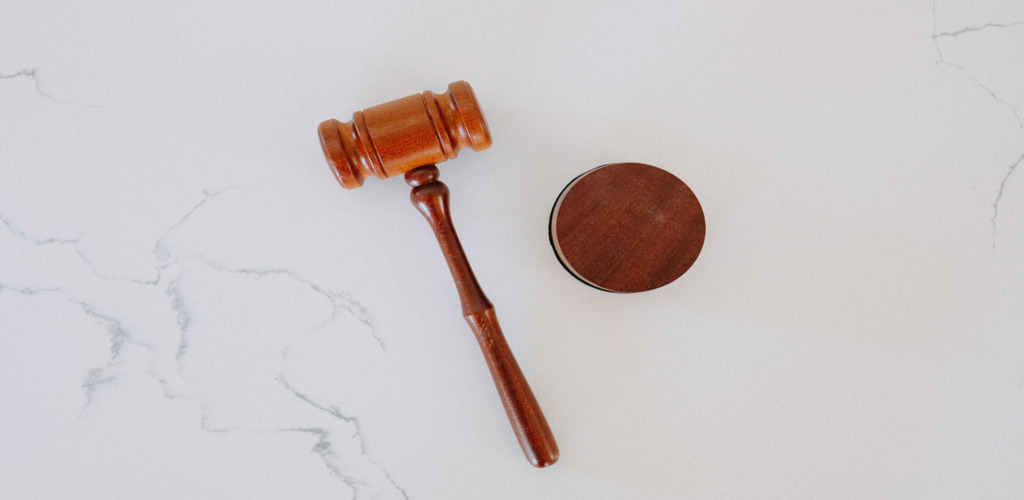 A wooden gavel on a marble desk