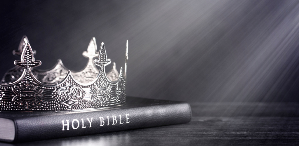 A crown on a Bible with sunbeams