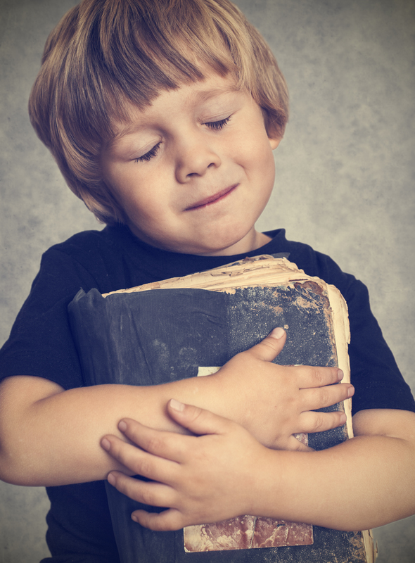 a kid hugging a book