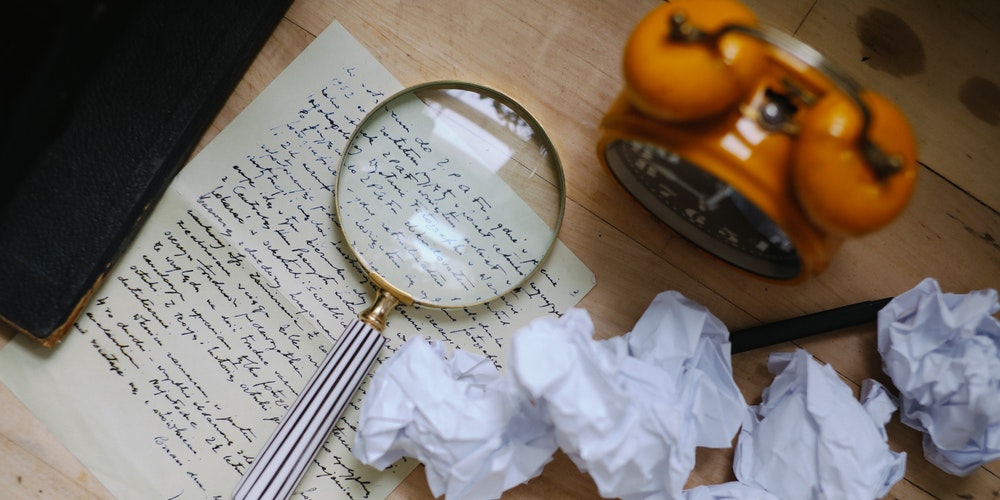 Magnifying glass with crumpled papers
